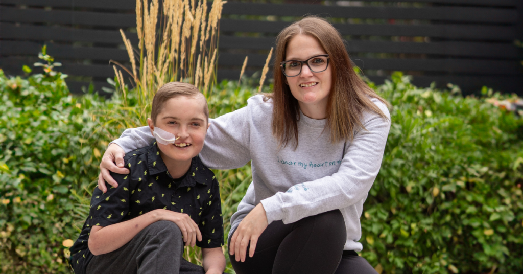 A boy and a woman outside