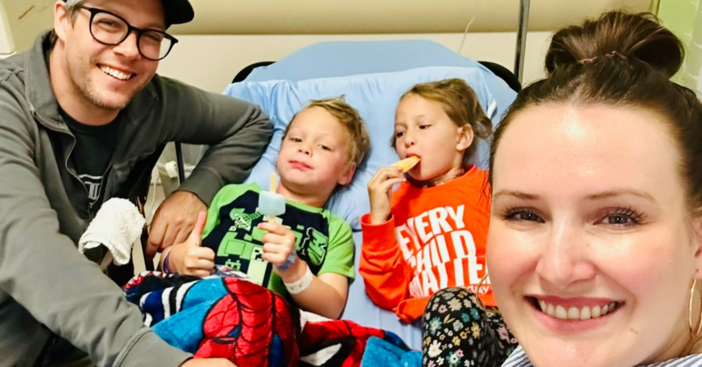 A family of four on a hospital bed