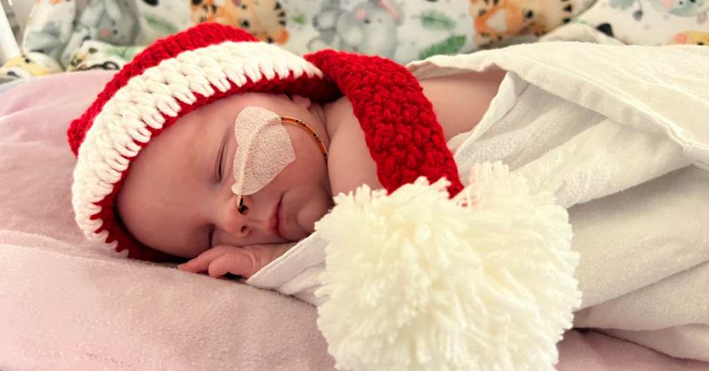A baby in a Santa hat